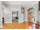 Bright foyer showcasing hardwood floors and an elegant entry door at 19 Spring Lake Trl, White, GA 30184