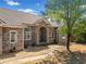 Charming brick house with arched entry, featuring a welcoming front yard and mature landscaping at 19 Spring Lake Trl, White, GA 30184