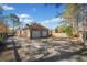 A two-car, brick garage with a wide driveway and mature trees at 19 Spring Lake Trl, White, GA 30184