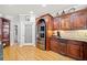Well-lit kitchen with custom wood cabinets, pantry, and stainless steel refrigerator at 19 Spring Lake Trl, White, GA 30184