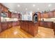 Kitchen features ample counter space, rich wooden cabinets, and an island with bar seating at 19 Spring Lake Trl, White, GA 30184