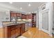Large kitchen with an island, pantry, wooden cabinets, and stainless steel appliances at 19 Spring Lake Trl, White, GA 30184