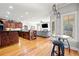 Open kitchen with hardwood floors, bar seating, and a seamless view into the living room at 19 Spring Lake Trl, White, GA 30184