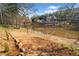 Lakeside lot with sandy beach and wooded views, offering a peaceful retreat at 19 Spring Lake Trl, White, GA 30184