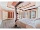 Spacious main bedroom with a large four-poster bed, tray ceilings, and french doors at 19 Spring Lake Ne Trl, White, GA 30184