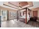 Spacious main bedroom with tray ceilings, a four-poster bed, and access to the backyard at 19 Spring Lake Trl, White, GA 30184