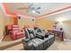 Home theater featuring tiered seating with reclining chairs, sconces, and a ceiling fan at 19 Spring Lake Ne Trl, White, GA 30184