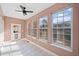 Bright sunroom with tile flooring, a ceiling fan, and large windows offering picturesque views at 19 Spring Lake Trl, White, GA 30184