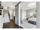 Open view from the hallway into a bedroom with wood floors and a neutral color scheme at 1980 Flying Scotsman Dr # 10, Kennesaw, GA 30144
