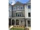 Attractive townhome boasting a covered porch, brick accents, and professionally landscaped front yard, creating an inviting entrance at 1980 Flying Scotsman Dr # 10, Kennesaw, GA 30144