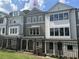 Charming townhome featuring a covered entrance, brick accents, and neutral-colored siding, creating a welcoming curb appeal at 1980 Flying Scotsman Dr # 10, Kennesaw, GA 30144