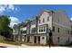 Exterior shot of new townhomes featuring grey and white siding, stone accents, and well-maintained landscaping at 1980 Flying Scotsman Dr # 10, Kennesaw, GA 30144