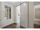Bright foyer featuring a barn door and a view into a carpeted room at 1980 Flying Scotsman Dr # 10, Kennesaw, GA 30144