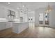 Spacious, well-lit kitchen with white cabinetry, quartz countertops, stainless steel appliances, and hardwood floors at 1980 Flying Scotsman Dr # 10, Kennesaw, GA 30144