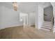 Open-concept living space with hardwood floors and staircase at 1980 Flying Scotsman Dr # 10, Kennesaw, GA 30144