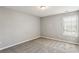 Well-lit bedroom featuring neutral walls and carpet flooring at 4658 Grand Central Pkwy, Decatur, GA 30035