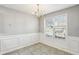 Formal dining area with wainscoting, tile flooring, and a chandelier at 4658 Grand Central Pkwy, Decatur, GA 30035