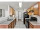 Galley kitchen featuring granite countertops and wood cabinets at 4658 Grand Central Pkwy, Decatur, GA 30035