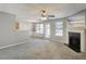 Spacious living room featuring a fireplace, ceiling fan, and neutral color palette at 4658 Grand Central Pkwy, Decatur, GA 30035