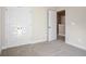 Spacious bedroom with neutral walls and carpet, double doors, and access to hallway at 500 Paces Dr, Lithia Springs, GA 30122