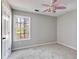 Bright bedroom with carpet flooring and a window offering woodland views at 121 Rachel Blvd, Temple, GA 30179