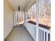 Spacious front porch with white railings overlooking a wooded area at 121 Rachel Blvd, Temple, GA 30179