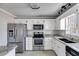 Kitchen boasts stainless steel appliances and granite countertops at 121 Rachel Blvd, Temple, GA 30179