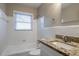 Bathroom featuring tiled tub and shower, granite countertop, and vanity at 3234 Bluebird Ln, Decatur, GA 30032