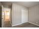 Bedroom with wall paneling, carpet and a large closet for storage at 3234 Bluebird Ln, Decatur, GA 30032