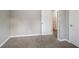 Bedroom with wall-to-wall carpet, closet and a door leading to hallway at 3234 Bluebird Ln, Decatur, GA 30032