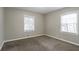 Bedroom featuring two windows letting in ample light and neutral color palette at 3234 Bluebird Ln, Decatur, GA 30032