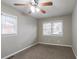 Neutral bedroom with new carpet, ceiling fan and two windows at 3234 Bluebird Ln, Decatur, GA 30032