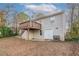 Exterior view of the home with a walkout basement and wooden deck at 3234 Bluebird Ln, Decatur, GA 30032