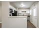 Bright kitchen featuring granite countertops, stainless steel appliances, and white cabinetry at 3234 Bluebird Ln, Decatur, GA 30032