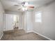 Main bedroom with modern ceiling fan, new carpet and access to ensuite bathroom at 3234 Bluebird Ln, Decatur, GA 30032