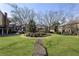 Exterior view of community featuring large green lawn and mature trees at 1634 Ponce De Leon Ne Ave # 503, Atlanta, GA 30307