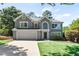 Two-story house with gray siding, a large yard, and a two-car garage at 165 Nesbit Ridge Dr, Roswell, GA 30076