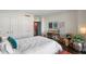 Bright bedroom with white bedding, built-in desk, and hardwood floors at 2660 Peachtree Rd # 27E, Atlanta, GA 30305