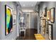 Long hallway with gray walls, hardwood floors, and gallery-style art display at 2660 Peachtree Rd # 27E, Atlanta, GA 30305