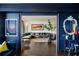 Dark blue living room with hardwood floors and view into another living area at 2660 Peachtree Rd # 27E, Atlanta, GA 30305