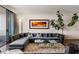 Modern living room featuring a large sectional sofa and city views at 2660 Peachtree Rd # 27E, Atlanta, GA 30305