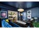 Sophisticated living room features dark blue walls, unique artwork, and comfortable seating at 2660 Peachtree Rd # 27E, Atlanta, GA 30305