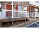 Small front porch with a wooden railing and red door at 3607 Ginnis Sw Dr # 7, Atlanta, GA 30331