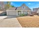 Charming one-story house with gray siding, a two-car garage, and a well-manicured lawn at 501 Olympic Way, Acworth, GA 30102