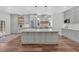 Modern kitchen boasts white cabinets, quartz countertops, and an island at 501 Olympic Way, Acworth, GA 30102