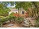 Home's back features a deck and stone pathway at 521 E Wesley Ne Rd, Atlanta, GA 30305