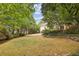 Large backyard with grassy area and stone retaining wall at 521 E Wesley Ne Rd, Atlanta, GA 30305