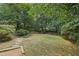 Landscaped backyard featuring a grassy area and stone pathways at 521 E Wesley Ne Rd, Atlanta, GA 30305