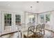 Sunlit dining room with glass table and access to deck at 521 E Wesley Ne Rd, Atlanta, GA 30305