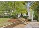 Charming white brick home with landscaping and stone wall at 521 E Wesley Ne Rd, Atlanta, GA 30305